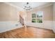 Formal dining room with decorative molding, light hardwood floors, modern chandelier and bright window at 71 Anita Se Pl, Mableton, GA 30126