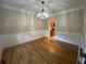 Elegant dining room with hardwood floors, wainscoting, crown molding, and modern chandelier at 71 Anita Se Pl, Mableton, GA 30126