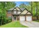 Charming two-story home with a brick facade, two-car garage, and well-manicured lawn and mature trees at 71 Anita Se Pl, Mableton, GA 30126