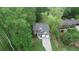 Charming two-story home with a two-car garage and landscaped front yard surrounded by mature trees at 71 Anita Se Pl, Mableton, GA 30126