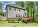 The home's exterior features a spacious deck, green yard, and mature trees for privacy at 71 Anita Se Pl, Mableton, GA 30126