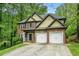 Charming two-story home with a brick facade, two-car garage, and well-manicured lawn and mature trees at 71 Anita Se Pl, Mableton, GA 30126