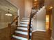 Inviting foyer with hardwood floors, staircase with iron spindles, and stylish lighting at 71 Anita Se Pl, Mableton, GA 30126