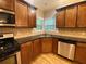 The kitchen features stainless steel appliances, wooden floors, and dark countertops at 71 Anita Se Pl, Mableton, GA 30126