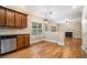 Eat-in kitchen with stainless steel appliances, dark cabinets, and seamless flow to living room at 71 Anita Se Pl, Mableton, GA 30126