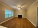 Spacious living room with fireplace, ceiling fan, and large window at 71 Anita Se Pl, Mableton, GA 30126