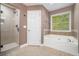 Main bathroom with separate glass shower, soaking tub, and tiled accents at 71 Anita Se Pl, Mableton, GA 30126