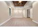 Large main bedroom with decorative tray ceiling, carpeting, and elegant lighting fixtures at 71 Anita Se Pl, Mableton, GA 30126