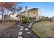 Spacious backyard with a covered patio, lush landscaping, and a stepping stone path at 1070 Cureton Dr, Austell, GA 30106