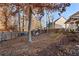 Large backyard featuring mature trees, a wooden fence, and ample space for outdoor activities and entertaining at 1070 Cureton Dr, Austell, GA 30106