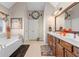 Bright primary bathroom with double vanity, soaking tub, and neutral finishes at 1070 Cureton Dr, Austell, GA 30106