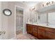 Bathroom featuring a double vanity, shower, bathtub, and updated lighting fixtures at 1070 Cureton Dr, Austell, GA 30106