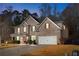 Charming two-story brick home with a well-manicured lawn, attached two car garage, and inviting front entrance at 1070 Cureton Dr, Austell, GA 30106