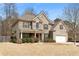 Charming two-story brick home with a manicured lawn and inviting front porch at 1070 Cureton Dr, Austell, GA 30106