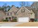 Lovely brick home with a two-car garage, nice landscaping, and a red front door at 1070 Cureton Dr, Austell, GA 30106