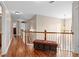 Second story hallway with wood floors, neutral paint, bench seating and bright natural light at 1070 Cureton Dr, Austell, GA 30106