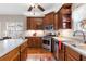 Bright kitchen with stainless appliances, wood cabinets, counter space and a view into the backyard at 1070 Cureton Dr, Austell, GA 30106