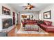 Welcoming living room with fireplace, hardwood floors, and a seamless transition to the kitchen at 1070 Cureton Dr, Austell, GA 30106