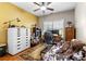 Cozy home office with neutral paint, wood floors, ceiling fan, a desk area and a comfortable seating area at 1070 Cureton Dr, Austell, GA 30106