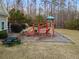 Community playground with slides, ladders, and picnic tables in a grassy area at 1070 Cureton Dr, Austell, GA 30106