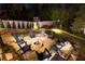 Backyard fire pit area featuring a stone patio and a ring of Adirondack chairs at 1226 Goodwin Ne Rd, Atlanta, GA 30324