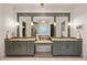 This bathroom has double sinks, framed mirrors, granite countertops, and tile flooring at 1226 Goodwin Ne Rd, Atlanta, GA 30324