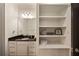 Bathroom featuring a dark granite countertop, white vanity, and open shelving at 1226 Goodwin Ne Rd, Atlanta, GA 30324