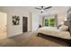 Bedroom with modern fan, plush carpet, and an attached bathroom at 1226 Goodwin Ne Rd, Atlanta, GA 30324