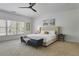 This bedroom has a ceiling fan, a bench, and a large window with natural light at 1226 Goodwin Ne Rd, Atlanta, GA 30324