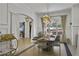 Bright dining room boasts modern chandelier, elegant decor, and ample natural light from large window at 1226 Goodwin Ne Rd, Atlanta, GA 30324