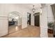 Elegant foyer featuring herringbone wood floors, a large arched mirror, and paneled walls at 1226 Goodwin Ne Rd, Atlanta, GA 30324