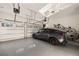 Garage with white door, electric vehicle, bikes, and coated flooring at 1226 Goodwin Ne Rd, Atlanta, GA 30324