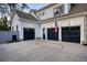 A spacious three-car garage with black doors and an American flag above it at 1226 Goodwin Ne Rd, Atlanta, GA 30324