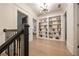 Hallway with hardwood floors and a built-in bookcase at 1226 Goodwin Ne Rd, Atlanta, GA 30324
