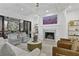 Open living room boasts a fireplace and seamless access to the covered outdoor living space at 1226 Goodwin Ne Rd, Atlanta, GA 30324