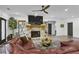 Spacious living room featuring a stone fireplace, mounted television, and modern furnishings at 1226 Goodwin Ne Rd, Atlanta, GA 30324