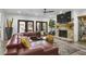 Open concept living room with a stone fireplace, large sofa, and natural light at 1226 Goodwin Ne Rd, Atlanta, GA 30324