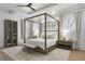 This is a main bedroom showcasing a four-poster bed, ceiling fan, and light gray walls with white trim at 1226 Goodwin Ne Rd, Atlanta, GA 30324