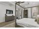 This main bedroom features a ceiling fan, a dresser with a mounted TV, and large windows with natural light at 1226 Goodwin Ne Rd, Atlanta, GA 30324