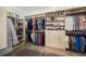 Walk-in closet with custom shelving and hanging racks for organized storage at 1226 Goodwin Ne Rd, Atlanta, GA 30324