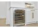 White built-in wine cooler with glass door situated under the kitchen counter at 1226 Goodwin Ne Rd, Atlanta, GA 30324