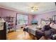 Cozy bedroom with hardwood floors, ceiling fan, and a light purple color scheme at 1522 Sprayberry Dr, Marietta, GA 30066