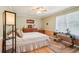 Cozy bedroom featuring a ceiling fan, bedside tables, and a large window for natural light at 1522 Sprayberry Dr, Marietta, GA 30066