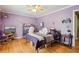 Bedroom with hardwood floors, natural light, ceiling fan, and light purple walls at 1522 Sprayberry Dr, Marietta, GA 30066