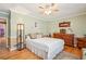 Comfortable bedroom with a ceiling fan, stylish decor, and wood flooring at 1522 Sprayberry Dr, Marietta, GA 30066