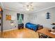 Bright bedroom showcasing wood floors, a ceiling fan, and large windows for plenty of natural light at 1522 Sprayberry Dr, Marietta, GA 30066