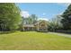 Beautiful yellow home with green shutters, manicured lawn, and a peaceful setting at 1522 Sprayberry Dr, Marietta, GA 30066