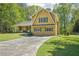 Well-maintained yellow home featuring green shutters and a long driveway at 1522 Sprayberry Dr, Marietta, GA 30066