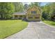 Charming two-story home with yellow siding, green shutters, and a well-manicured lawn at 1522 Sprayberry Dr, Marietta, GA 30066