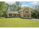 Charming yellow home with a welcoming front porch and vibrant green lawn at 1522 Sprayberry Dr, Marietta, GA 30066